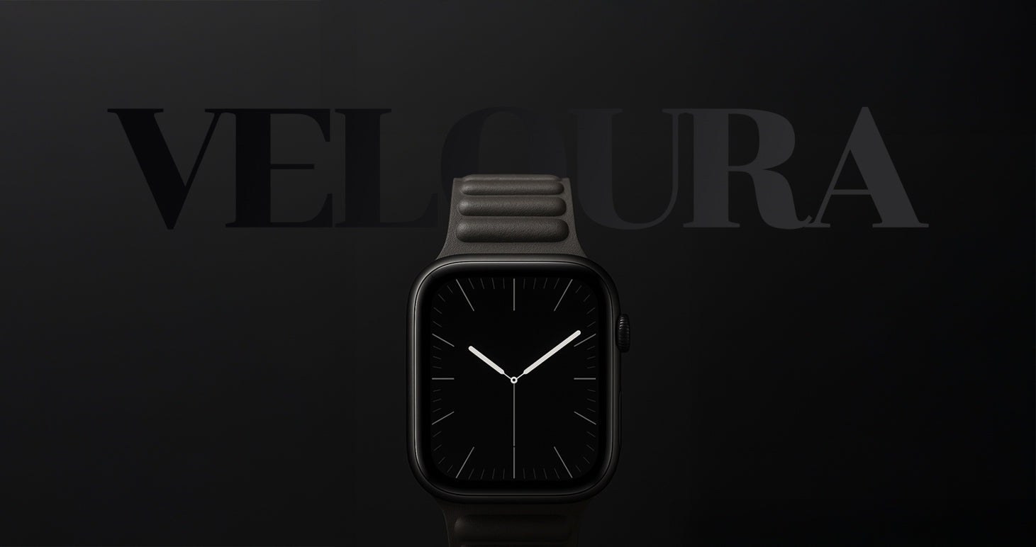 Apple Watch mit schwarzfarbenem, strukturiertem Armband-Modell „Veloura“ von miiwatch. Die Uhr zeigt ein minimalistisches Ziffernblatt mit weißem Sekunden-, Minuten- und Stundenzeiger. Im Hintergrund steht der Markenname „VELOURA“ in Großbuchstaben auf einem schwarzfarbenen Farbverlauf.