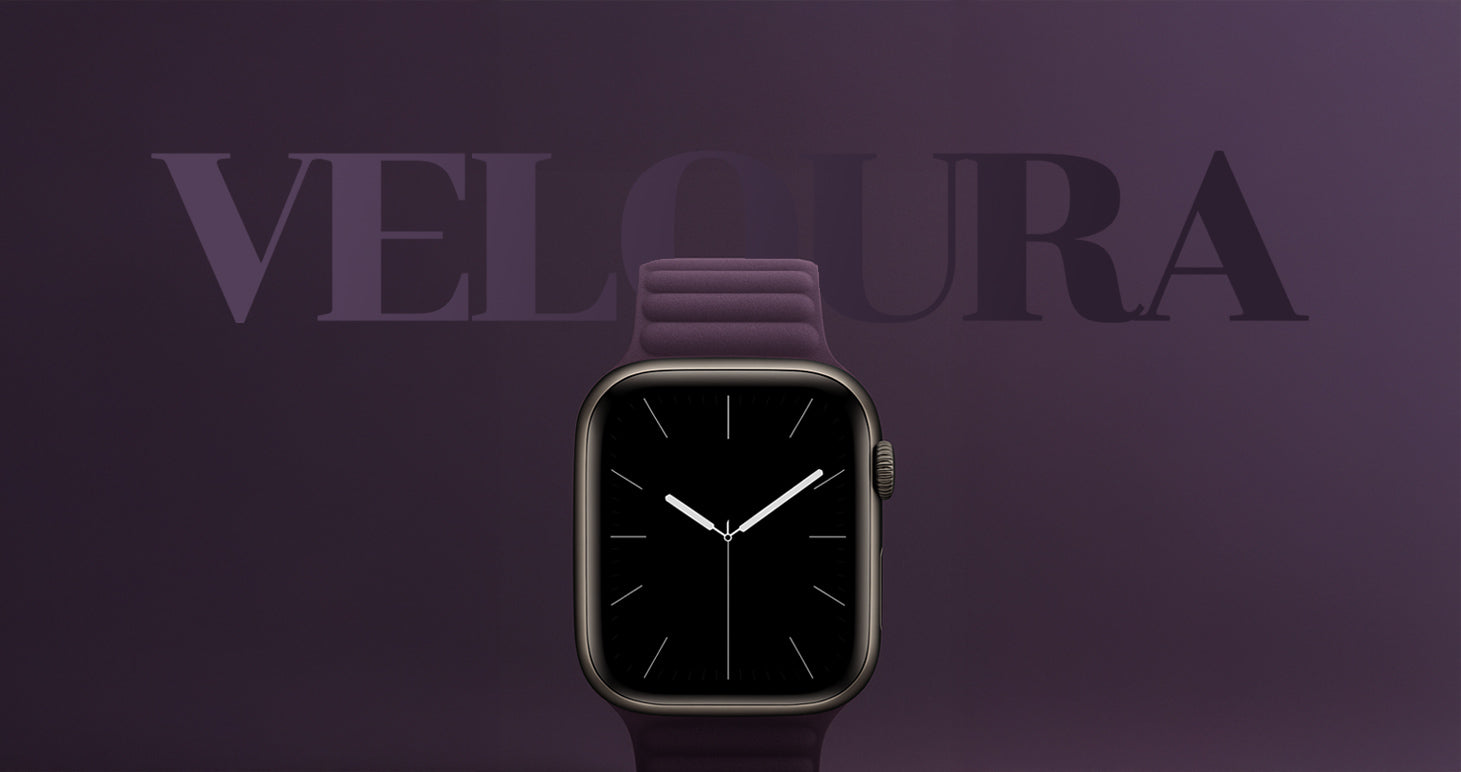 Apple Watch mit lilafarbenem, strukturiertem Armband-Modell „Veloura“ von miiwatch. Die Uhr zeigt ein minimalistisches Ziffernblatt mit weißem Sekunden-, Minuten- und Stundenzeiger. Im Hintergrund steht der Markenname „VELOURA“ in Großbuchstaben auf einem lilafarbenen Farbverlauf.